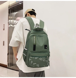 Detail view of military green backpack with safety reflective strip and padded straps