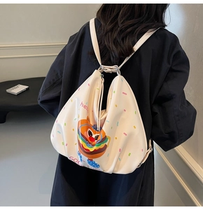 Detail of cute burger pattern on beige backpack with Hello and Good Luck prints