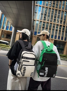 Close-up of contrast-color backpacks with 'SPECIAL' text and round coin pouch