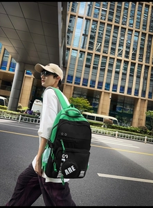 Detail of the high-capacity backpack featuring stylish black and green color contrast