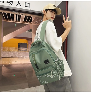 Close-up of bean green waterproof backpack with geometric print and multi-pocket design