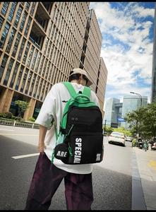 Street style black and neon green backpack with SPECIAL lettering and round pouch charm