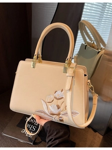 Elegant cream PU leather tote bag with floral embroidery and adjustable shoulder strap