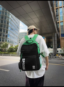 Detail of waterproof black and green backpack with bold Special lettering for students