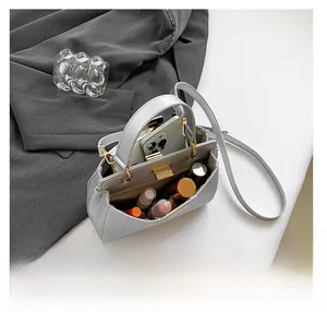 Interior view of silver-grey pebbled leather bag showing large capacity for cosmetics