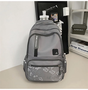 Detail view of the gray backpack showing high-capacity pockets and reflective safety strips