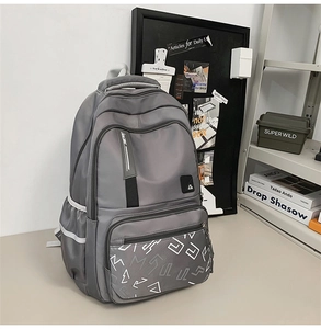 Detail of grey waterproof nylon backpack with reflective strips and spacious pockets