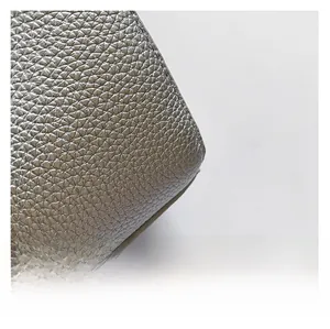 Detail of silver lychee grain leather handbag showing high-quality stitching and texture