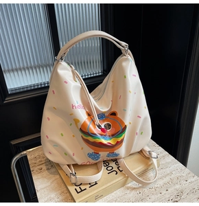 Close-up of a cream white burger backpack showing smooth texture and cartoon print details