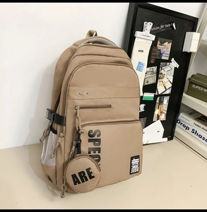 Detail view of khaki waterproof backpack with multi-pocket design and round coin purse