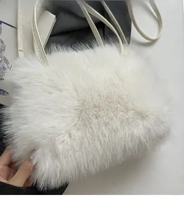 Close-up of fluffy white faux fur handbag with soft texture and slim leather handle