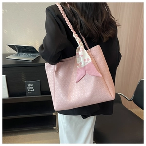 Pink faux leather tote bag with houndstooth texture and stylish woven handle with scarf