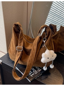 Large dark brown suede tote bag with adjustable strap and cute cloud charm accessory