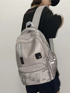 Gray waterproof minimalist backpack with multi-zipper compartments and reflective safety strip