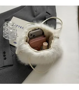 Interior detail of white plush handbag showing spacious storage for phone and wallet