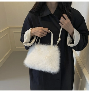 Close-up of white fluffy faux fur tote bag texture with elegant metallic strap hooks