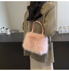 Chic pink faux fur tote bag shown on a model in a stylish coffee shop setting