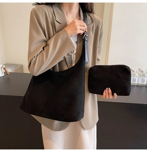 Detail of black faux suede hobo bag with adjustable leather strap and inner pouch
