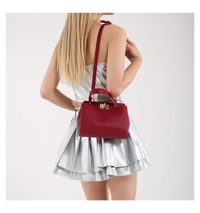 Red textured leather tote with golden twist lock shown by a model for a stylish look