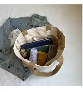 Large capacity canvas tote bag showing interior storage with tablet and accessories