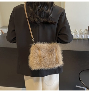 Detailed back view of a brown faux fur crossbody bag worn with a black blazer