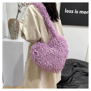 Vue détaillée du sac à épaule cœur en fausse fourrure violette duveteuse sur un modèle