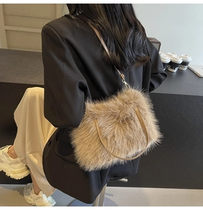 Detail of tan faux fur crossbody bag with leather strap on a model in a cafe setting