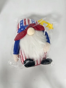 Detail of Fourth of July gnome plush toy with star in clear plastic packaging