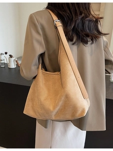 Large camel suede tote bag with smooth leather straps shown on a female model