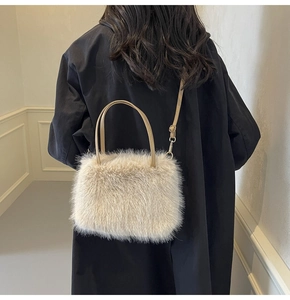 Plush faux fur crossbody bag in beige shown on model wearing a black winter coat
