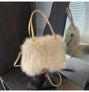 Close-up of plush faux fur handbag in cream color with gold hardware and leather strap