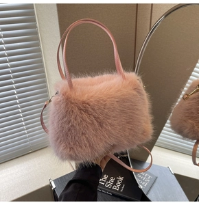 Detail of pink faux fur tote bag showing plush texture and thin leather shoulder strap