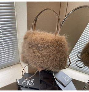 Detailed view of a brown plush tote bag with soft faux fur texture and leather handle