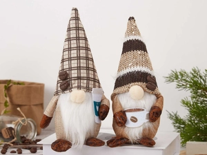 Detail of two coffee gnomes with knitted hats and mugs in a warm cafe setting