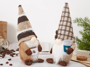 Detail of coffee gnome plush dolls with knit hats and cups on a cozy rustic wooden background
