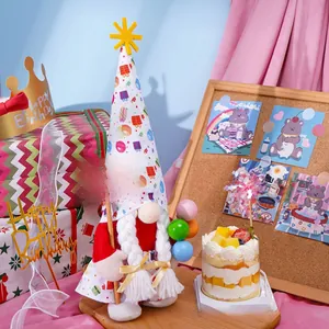 Close-up of birthday gnome holding a Happy Birthday sign with festive cake decor