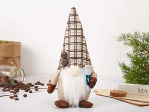 Detailed close-up of coffee gnome plush with plaid hat, coffee bean accents and white cup