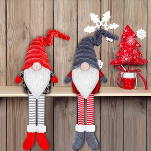 Close-up of long-legged Christmas gnomes with knit hats and plush white beards for home decor