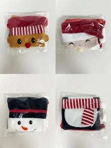 Close-up of four Christmas plush gift bags featuring Santa, reindeer, snowman, and penguin