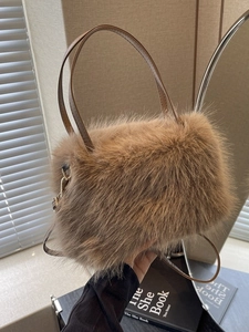 Plush faux fur handbag in tan brown with dual handles and detachable shoulder strap