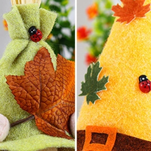 Detail of harvest gnome featuring maple leaf, red ladybug and felt fabric texture