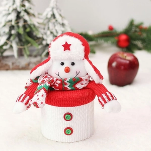 Macro view of a knitted snowman candy jar with a red star hat and colorful scarf