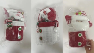 Three Christmas knitted gift jars featuring reindeer, snowman, and Santa motifs in packaging