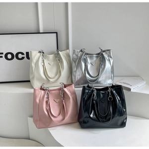 Collection of four glossy tote bags in white pink silver and black with chain handles