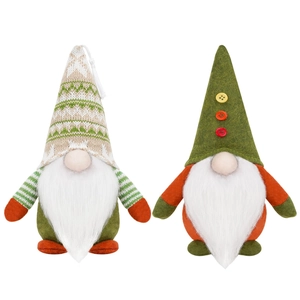 Two Christmas gnomes with green knitted hats and long white beards on a white background