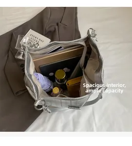 Overhead shot of silver tote bag showing spacious interior with laptop and daily essentials