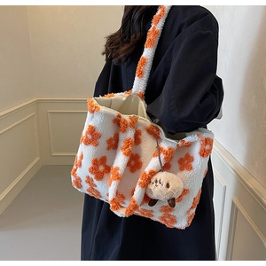 Winter plush tote bag with white and orange floral patterns and cute mascot charm