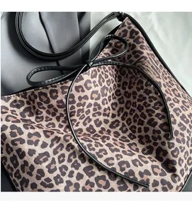 Detail of leopard print tote bag with black ribbon bow and slim shoulder straps