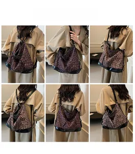 Leopard print bucket backpack model showcase with drawstring and black leather base