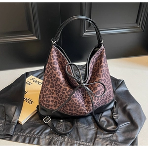 Leopard print canvas tote bag with black leather straps and versatile backpack conversion